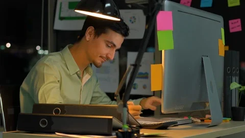 Businessman hard working with desktop computer to late night at office. Stock Footage 109299364