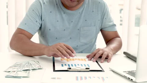 Businessman has analyzed graph and unhappy with result and throw dollar note Stock Footage 146107466
