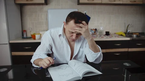 The businessman has problems, he is studying a book looking for a solution Stock Footage 130112027