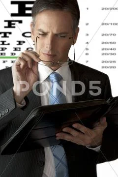 Businessman Has Trouble Seeing Stock Photos