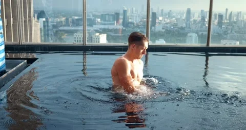 Businessman is having active conversation on cell phone in his luxury skyscraper Stock Footage 260043334