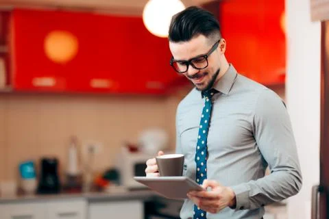 Businessman Having Coffee While Reading the News Stock Photos