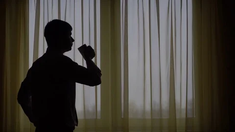 Businessman having a coffee at window. Stock Footage 70484175