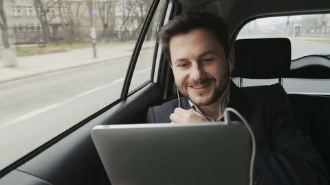 Businessman Having a Nice Tablet Skype Call in the Car Stock Footage 74499223