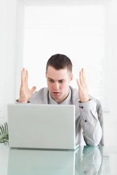 Businessman having problems with his notebook Stock Photos