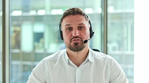 Businessman with Headset Talking to Client in Office Providing Online Stock Footage 304033281