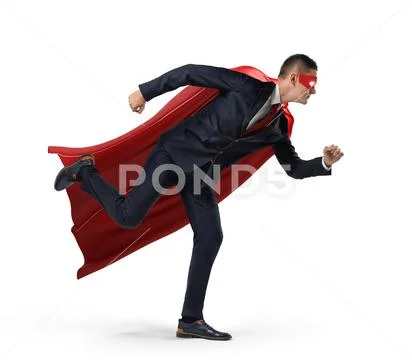 A businessman in a hero red cape and a mask in side view ready to run with one Stock Photos