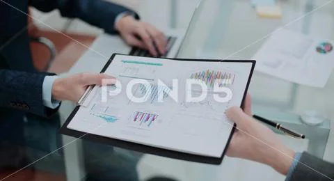 Businessman his colleague giving contract to read and sign Stock Photos