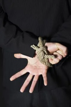 Businessman with his hands tied to the back Stock Photos