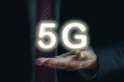 Businessman hold 5G network interface logo on his hand Stock Photos