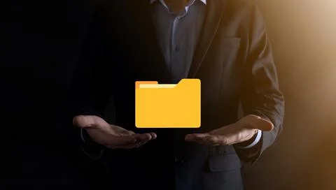 Businessman hold folder icon.Document Management System or DMS setup by IT co Stockfoto's