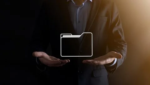Businessman hold folder icon.Document Management System or DMS setup by IT co Stockfoto's