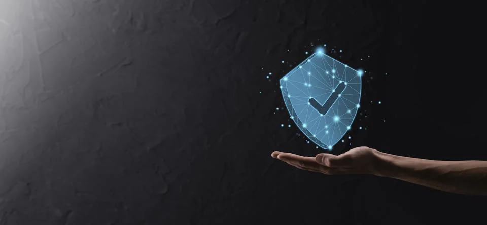 Businessman hold low poly polygon shield with a tick icon.Secure Access Syste Stock Photos
