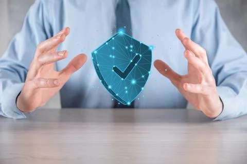 Businessman hold low poly polygon shield with a tick icon.Secure Access Syste Stock Photos