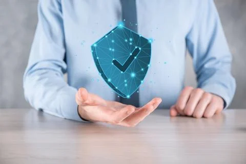 Businessman hold low poly polygon shield with a tick icon.Secure Access Syste Stock Photos