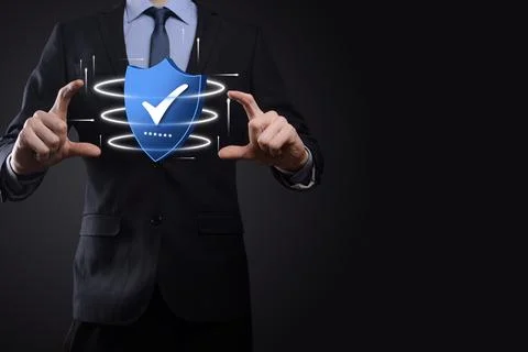 Businessman hold low poly polygon shield with a tick icon.Secure Access Syste Stockfoto's