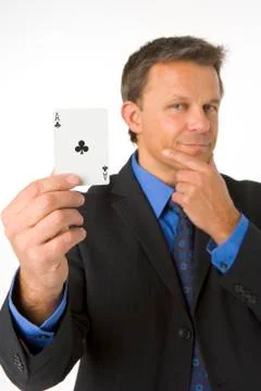 Businessman holding the ace of clubs Stock Photos