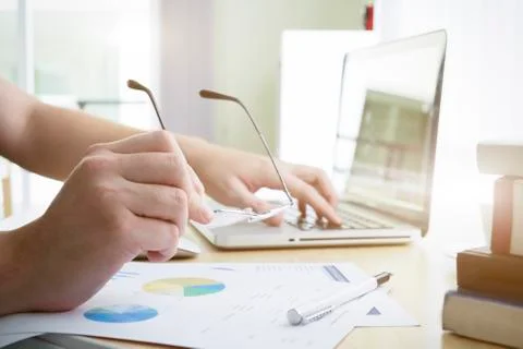 Businessman holding and using computer to analyse business marketing data onl Stock Photos