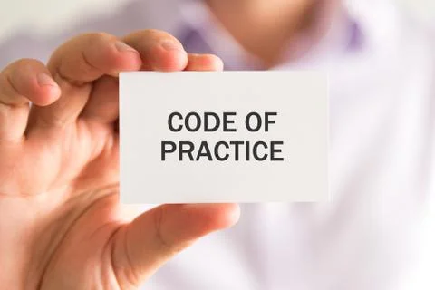 Businessman holding a card with CODE OF PRACTICE message Stock-Fotos
