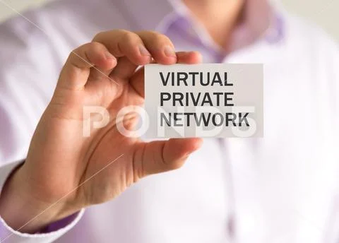 Businessman holding a card with VPN VIRTUAL PRIVATE NETWORK message Stock Photos