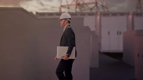 Businessman Holding Computer While Walking with Electrical Energy Stock Footage 331289287