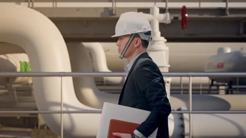 Businessman Holding Computer While Walking at Biodiesel plant Stock Footage 331639200