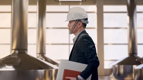 Businessman Holding Computer While Walking at Beer Plant Stock Footage 332160043