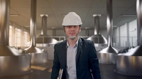 Businessman Holding Computer While Walking at Beer Plant Stock Footage 332160073