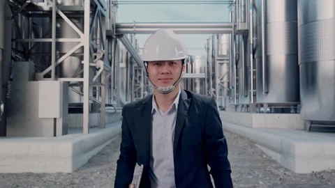 Businessman Holding Computer While Walking at Chemical Plant Stock Footage 332550105