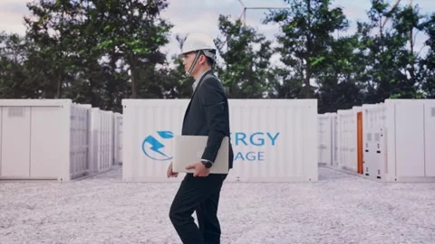 Businessman Holding Computer While Walking with Energy Storage Stock Footage 337811129