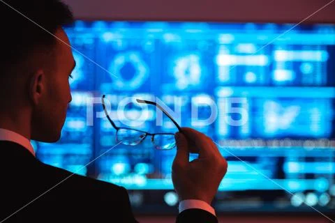 The businessman holding glasses on the screen background Stock Photos