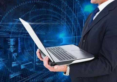 Businessman holding laptop with binary codes in background Stock Photos