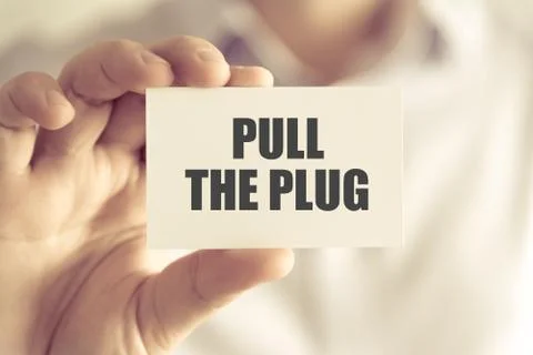 Businessman holding PULL THE PLUG message card Stock Photos