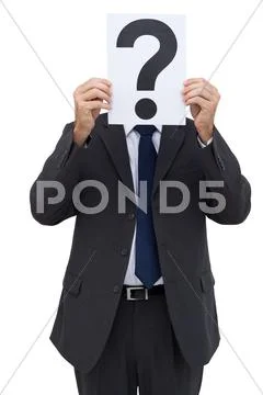 Businessman holding a question mark paper in front of his face Stock-Fotos