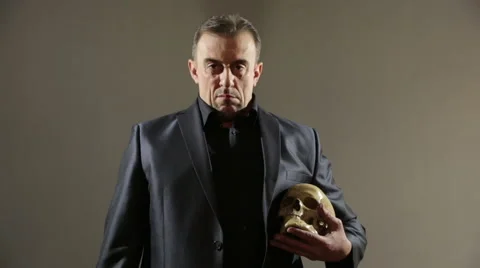 Businessman holding skull. gray background Stock Footage 63342018