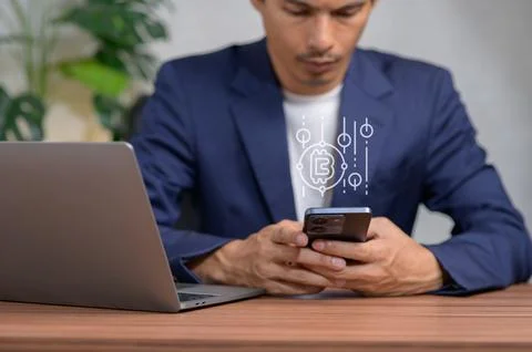 Businessman Holding Smartphone with Binary Code and Laptop Background Stockfoto's