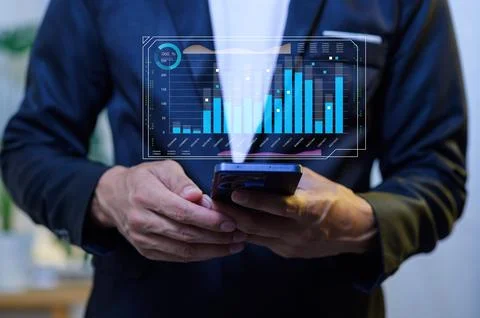 Businessman Holding Smartphone with Data Visualization on Screen Stock Photos
