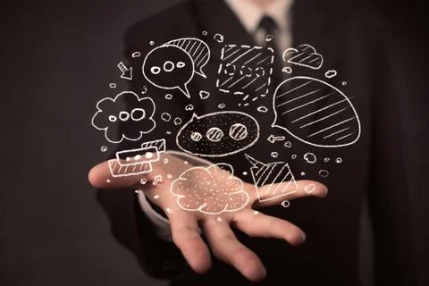 Businessman holding speech bubbles Foto stock