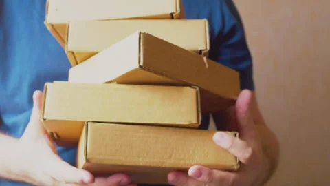 Businessman holding a stack of cardboard boxes 스톡 동영상 273500952