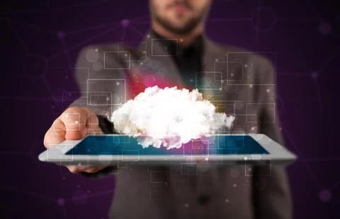 Businessman holding tablet with cloud graphic Foto stock