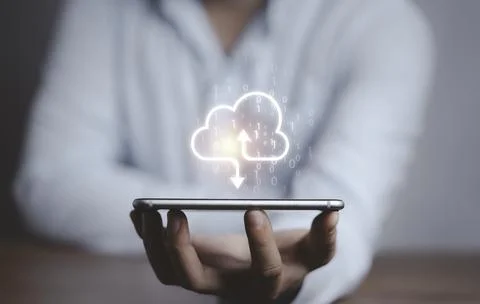 Businessman holding virtual cloud computing on smartphone to transfer data Stockfoto's