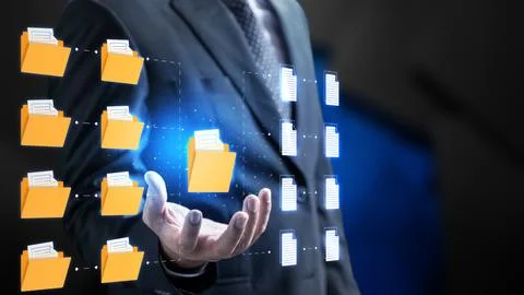 Businessman holding a virtual folder representing digital document manageme.. Stock Photos