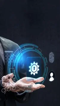 Businessman holds a digital interface featuring a security gear icon, biome.. Stock Photos