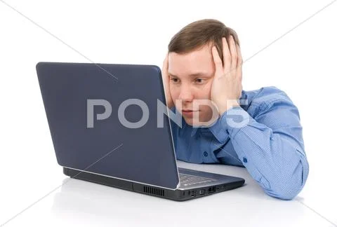 A businessman holds his head in his hands in desperation Stock Photos