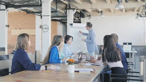 A businessman holds a presentation using a flipchart and draws graphics Stock Footage 111646803