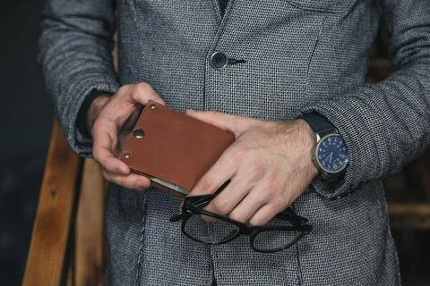 A businessman holds a wallet in his hands Stock Photos