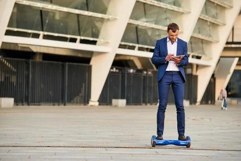 Businessman on hoverboard. Stock Photos
