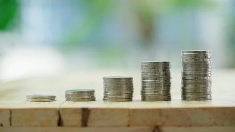 Businessman insert coins into stack coin. Saving money and business finance g Stock Footage 121211050