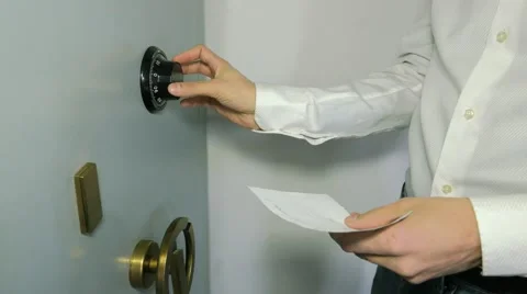 Businessman insert the combination to the safe Stock Footage 61488029