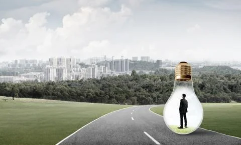 Businessman inside light bulb Stock Photos